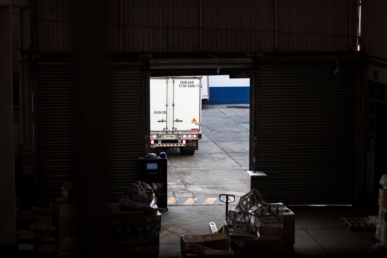 Delivery truck leaving a modern warehouse loading dock