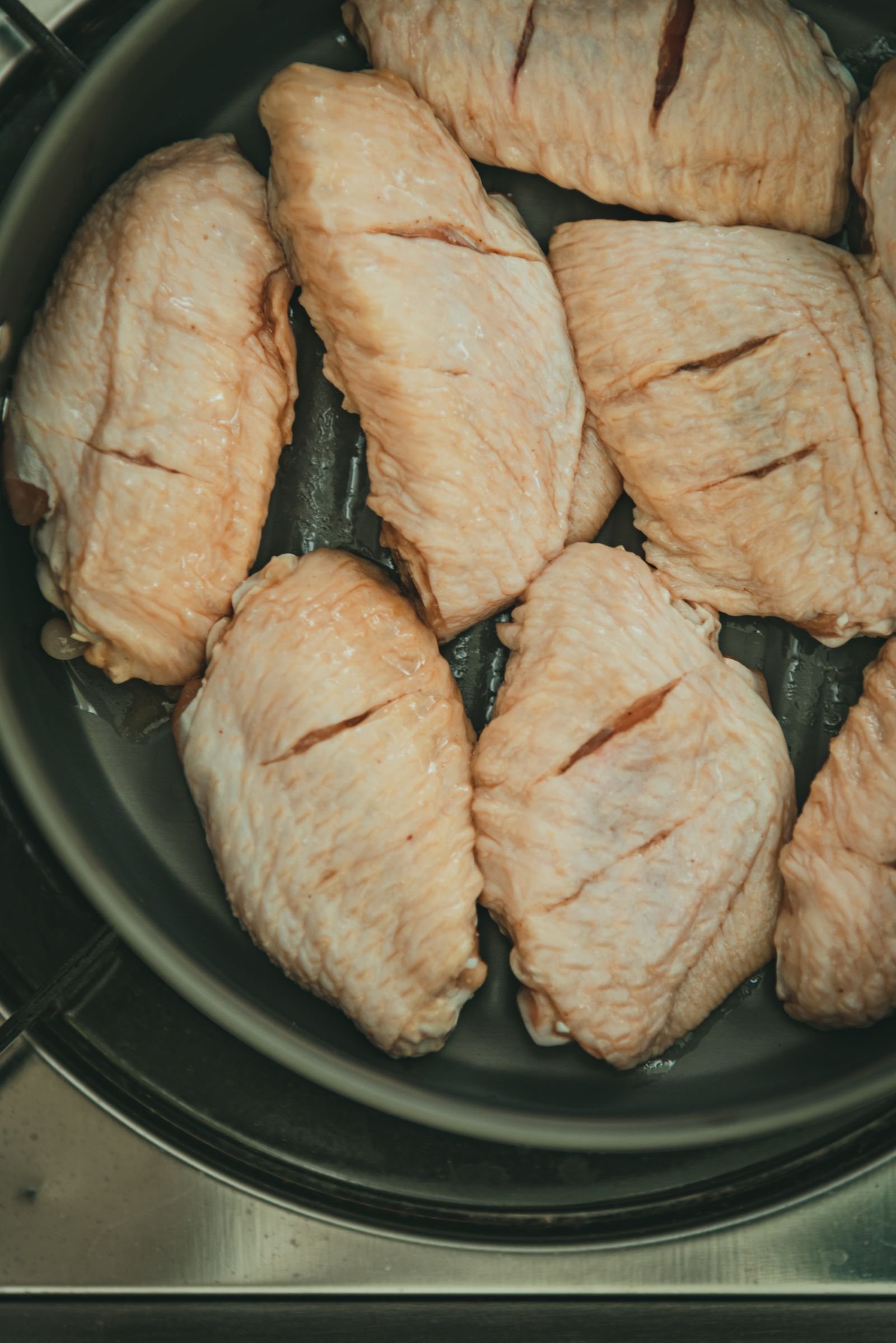 Raw poultry portions arranged in a chilled preparation pan